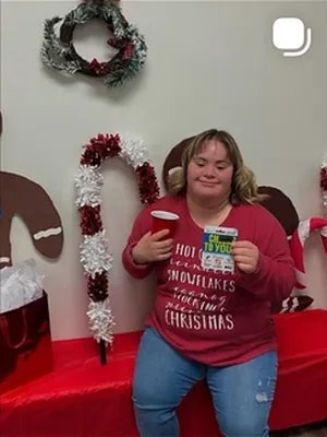 Before: A team member in a red holiday sweater