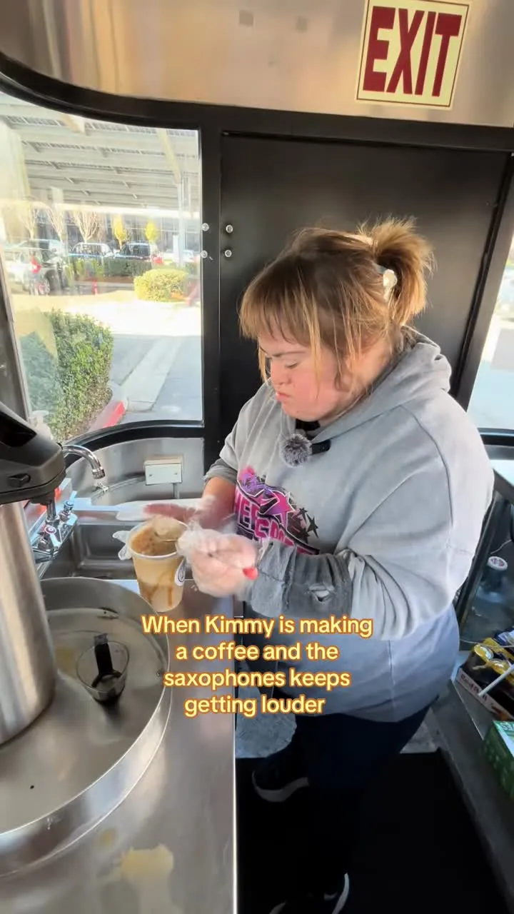 A barista making a coffee at the local coffee shop cart, caption: When Kimmy is making a coffee and the saxophones keep getting louder